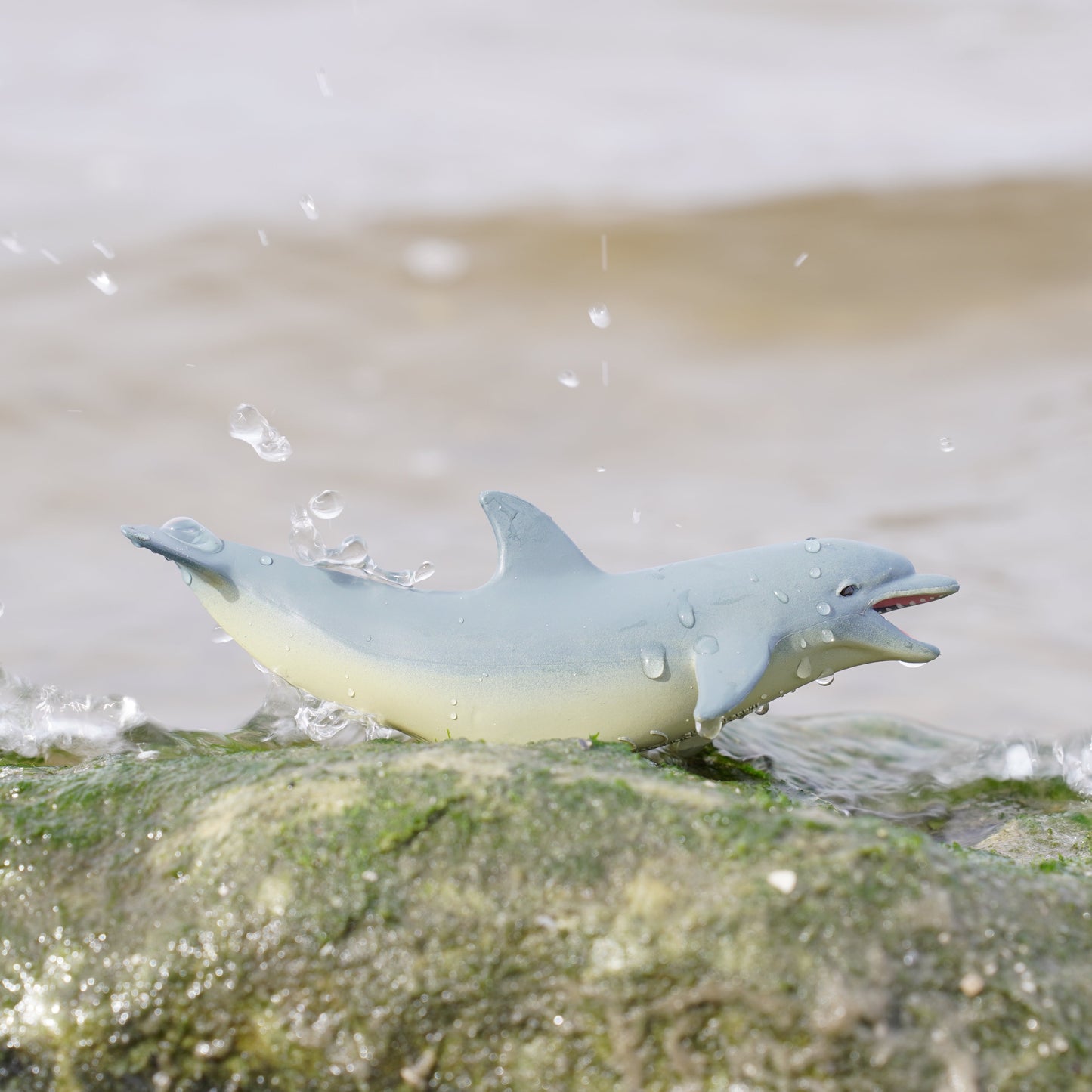 Safari Ltd Bottlenose Dolphin figurine on ocean rocks with water splash